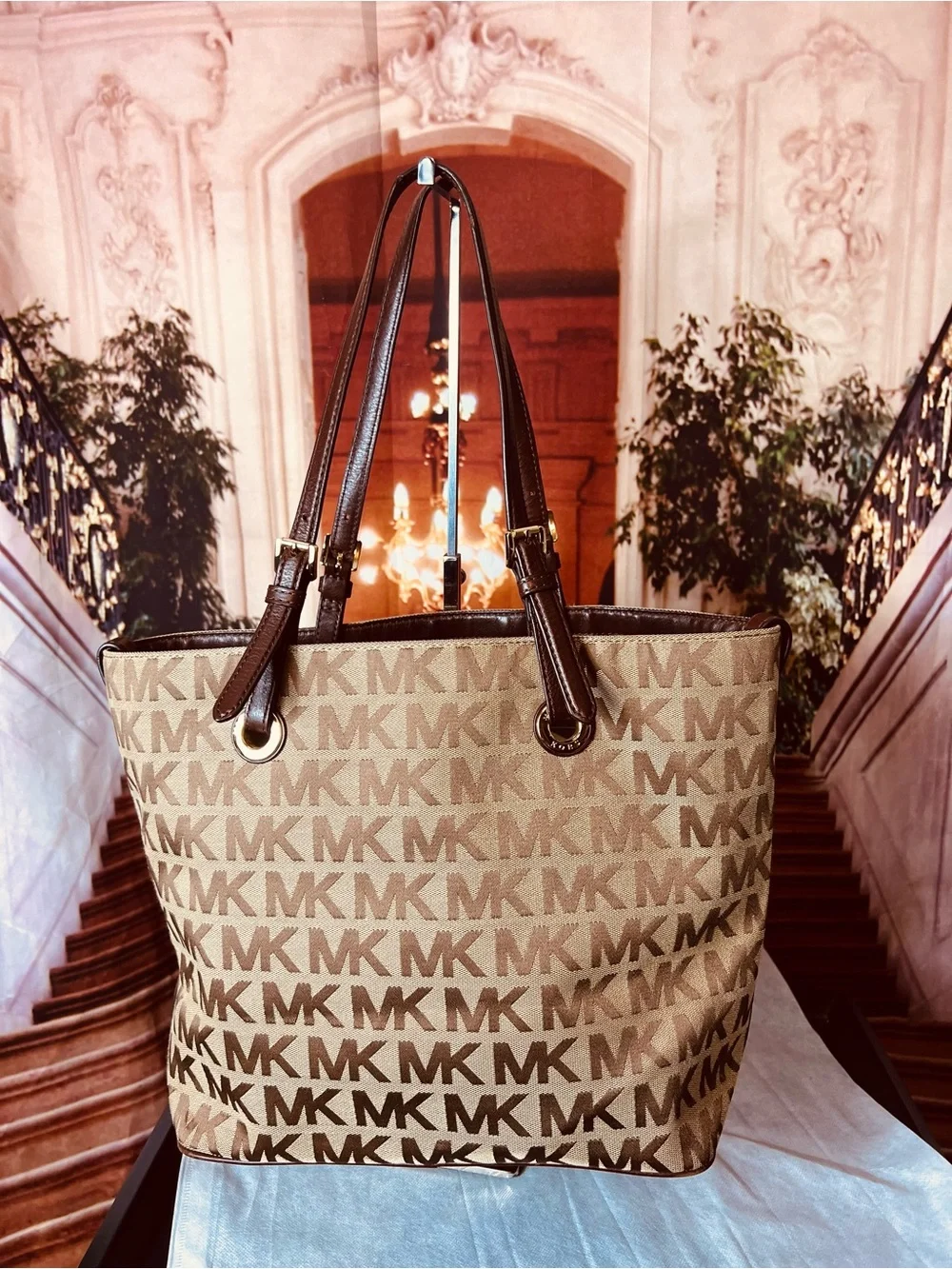 Michael Kors Jet Set tote features monogram canvas, contrasting leather straps